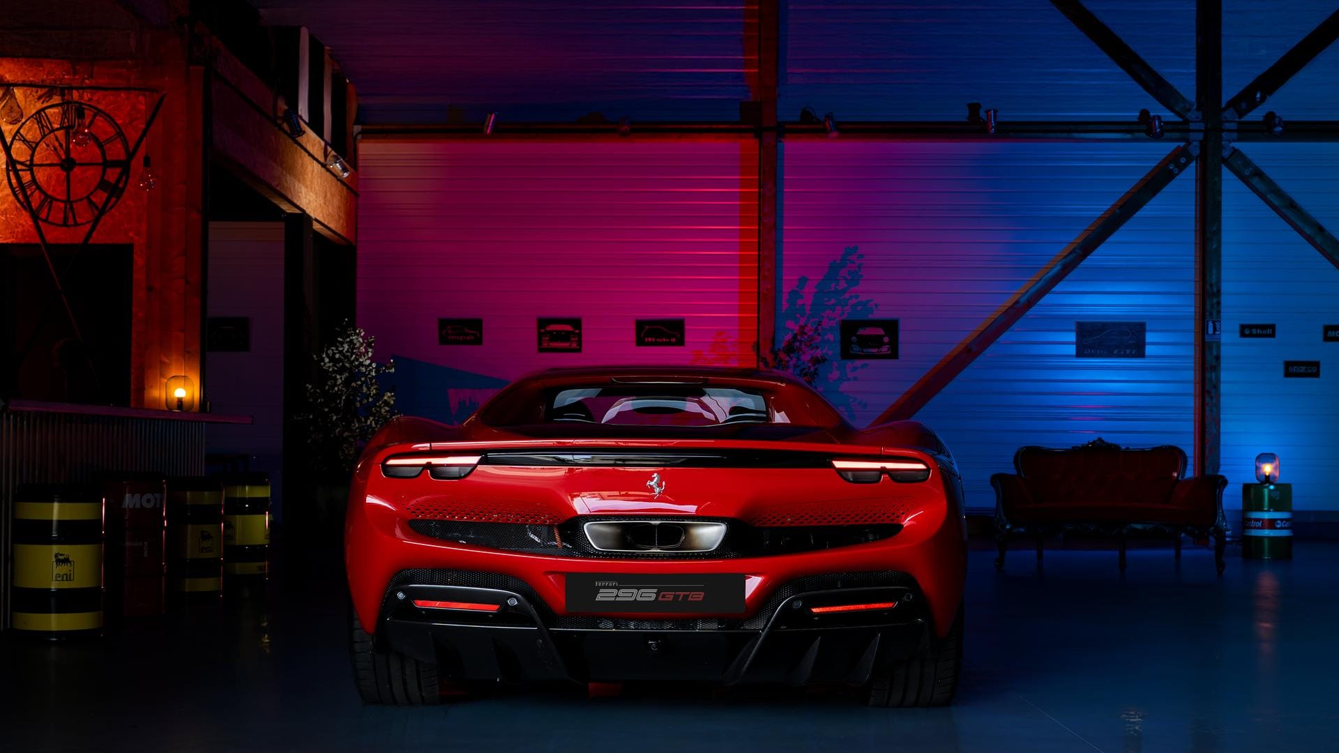 Red Ferrari 296 GTB under red and blue studio lighting