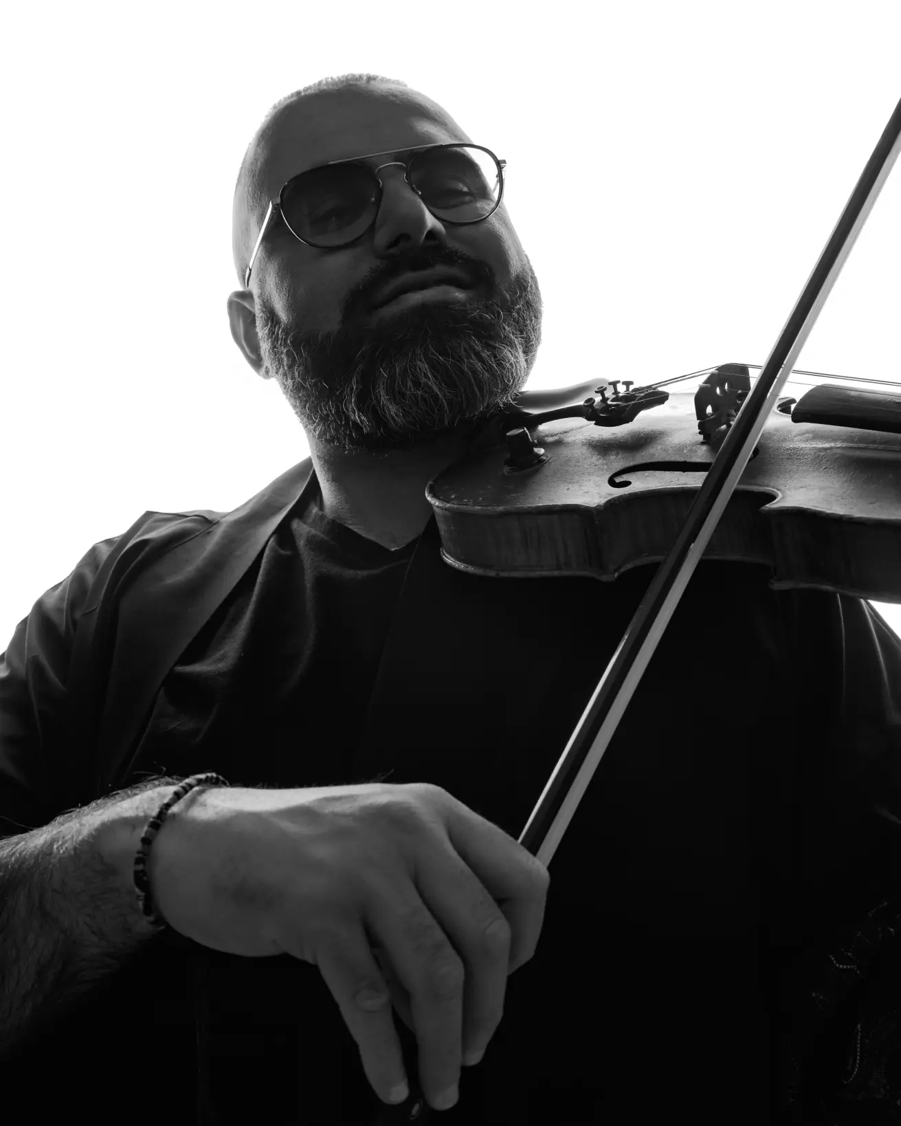 Black and white performance photograph of a violin player